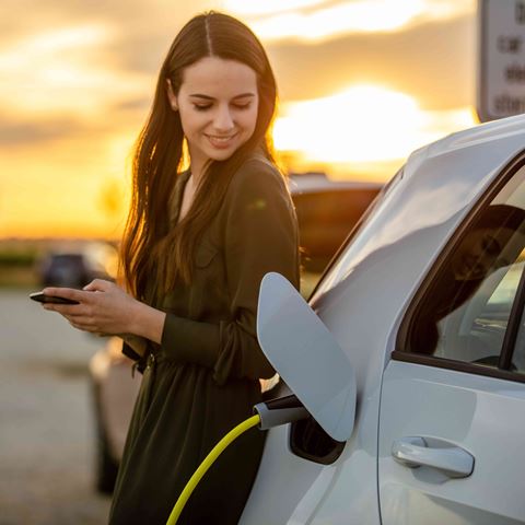 What is electric driving? woman charging car