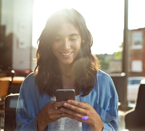 ZipperGirlinblueshirtlookingatphone2x