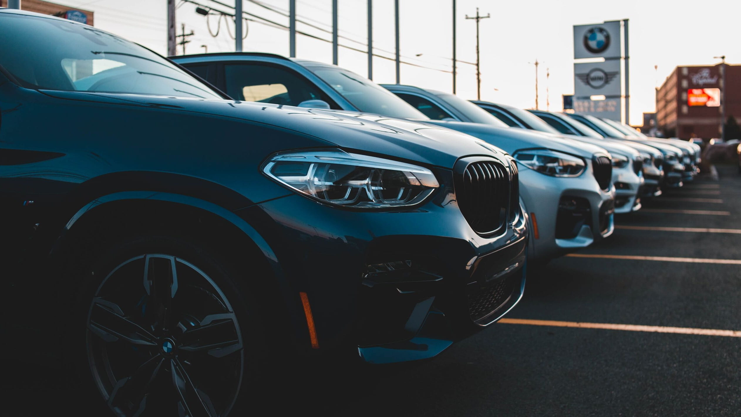 Cars in row on parking BMW and Mini in background